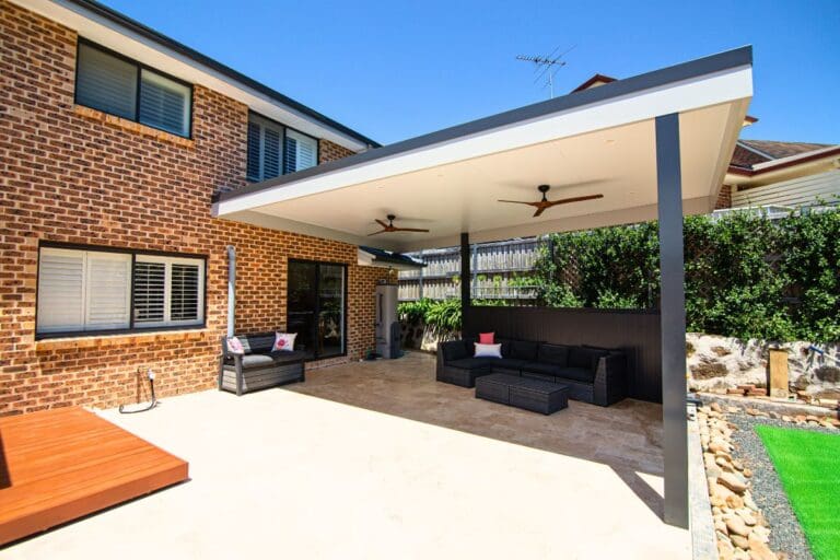 Covered patio extension with ceiling fans and outdoor lounge area, demonstrating how a patio deck can expand your home’s living space. Designed and built by Pergola Land.