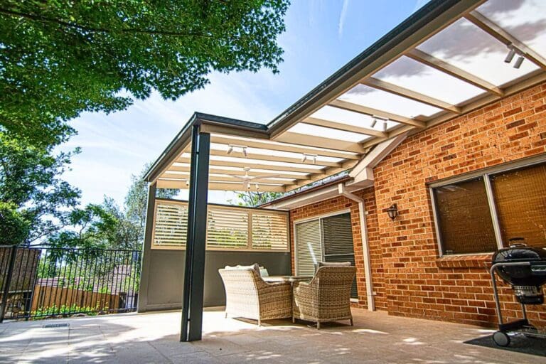 Light-filled pergola with transparent polycarbonate roofing and modern timber deck.